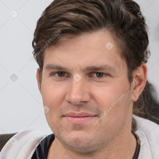 Joyful white adult male with short  brown hair and brown eyes