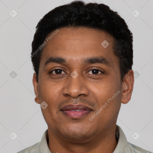 Joyful latino young-adult male with short  black hair and brown eyes