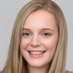 Joyful white young-adult female with long  brown hair and blue eyes