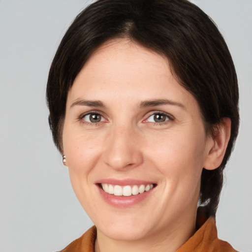 Joyful white young-adult female with medium  brown hair and brown eyes