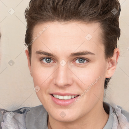 Joyful white young-adult female with short  brown hair and grey eyes