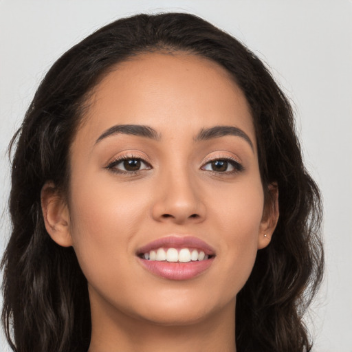 Joyful white young-adult female with long  brown hair and brown eyes