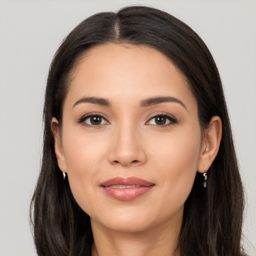 Joyful latino young-adult female with long  brown hair and brown eyes