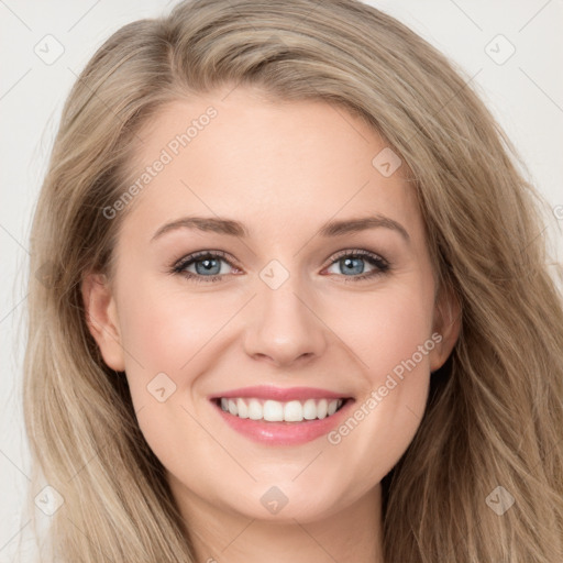 Joyful white young-adult female with long  brown hair and blue eyes