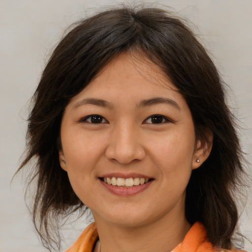 Joyful white young-adult female with medium  brown hair and brown eyes