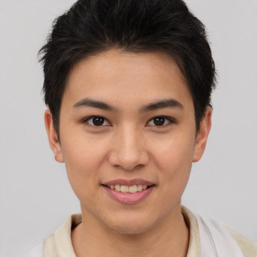 Joyful asian young-adult female with short  brown hair and brown eyes