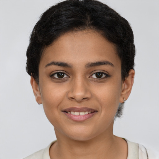 Joyful latino young-adult female with short  brown hair and brown eyes