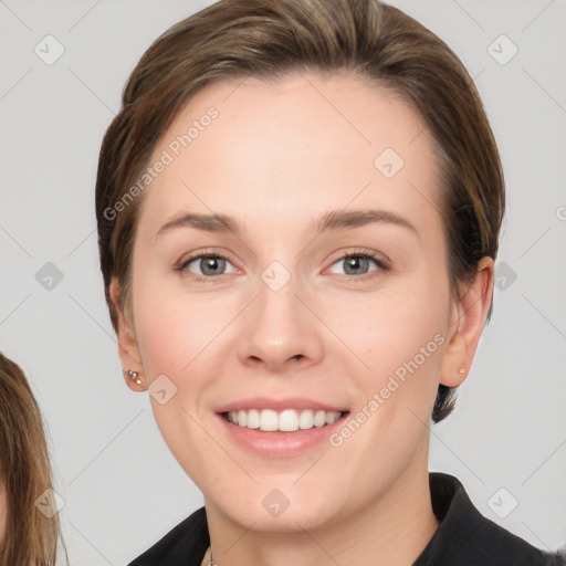 Joyful white young-adult female with medium  brown hair and green eyes