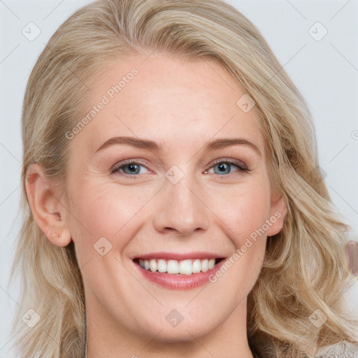 Joyful white young-adult female with long  brown hair and blue eyes