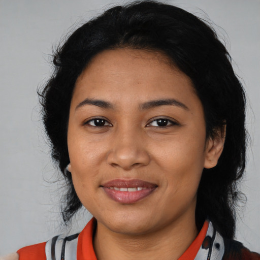 Joyful latino young-adult female with medium  black hair and brown eyes