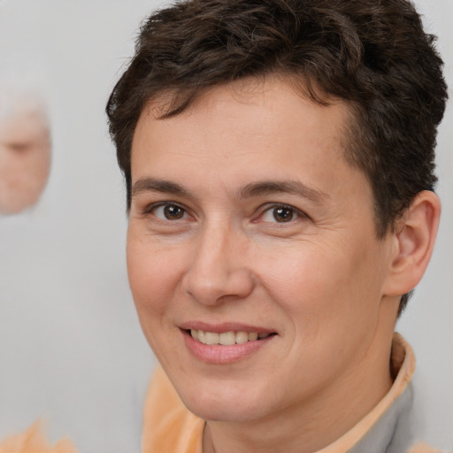 Joyful white adult male with short  brown hair and brown eyes