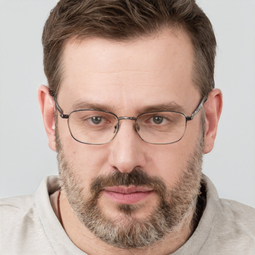 Joyful white adult male with short  brown hair and grey eyes