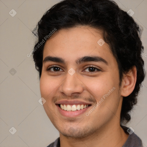 Joyful latino young-adult male with short  brown hair and brown eyes