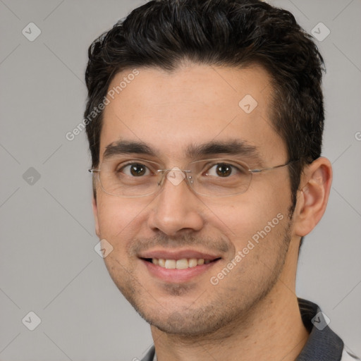 Joyful white adult male with short  black hair and brown eyes