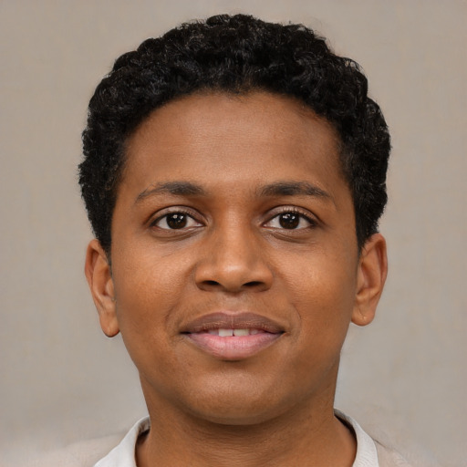 Joyful black young-adult male with short  black hair and brown eyes