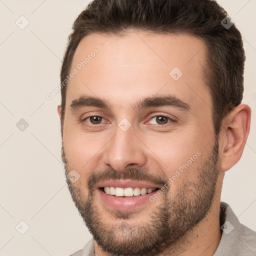 Joyful white young-adult male with short  brown hair and brown eyes