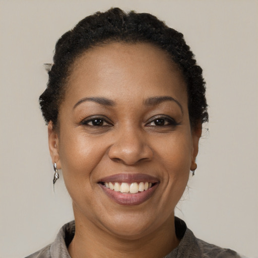 Joyful black adult female with short  brown hair and brown eyes