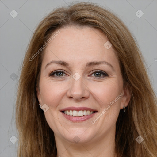 Joyful white adult female with long  brown hair and brown eyes