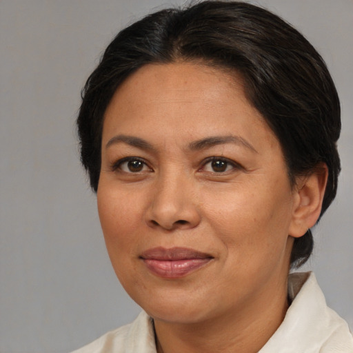 Joyful asian adult female with medium  brown hair and brown eyes