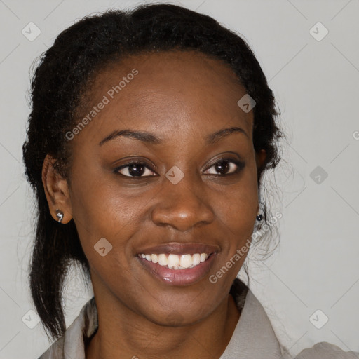 Joyful black young-adult female with long  brown hair and brown eyes