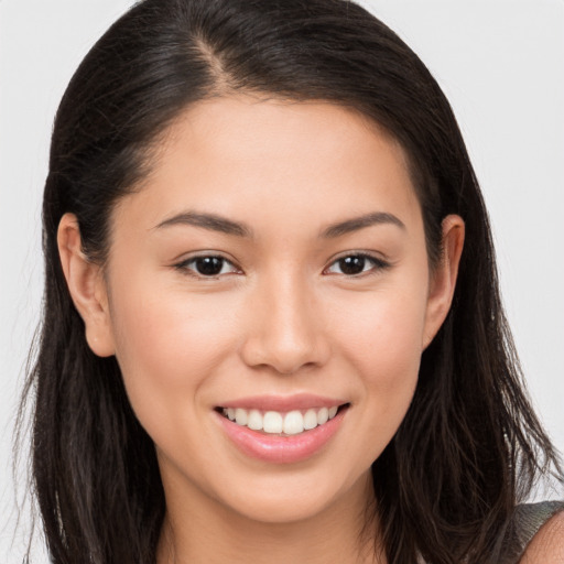 Joyful white young-adult female with long  brown hair and brown eyes