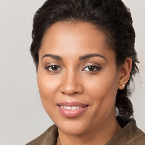 Joyful latino young-adult female with medium  brown hair and brown eyes