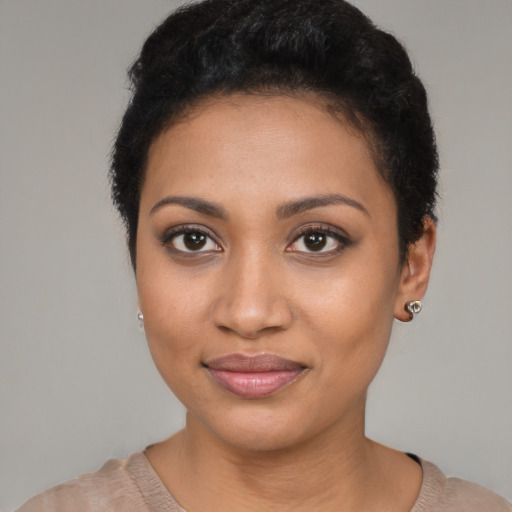 Joyful latino young-adult female with short  black hair and brown eyes