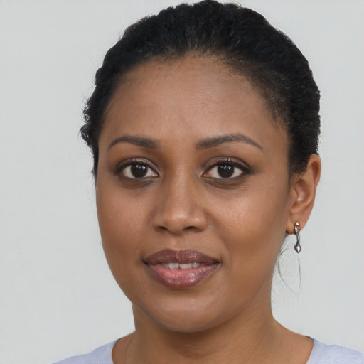 Joyful black young-adult female with short  brown hair and brown eyes
