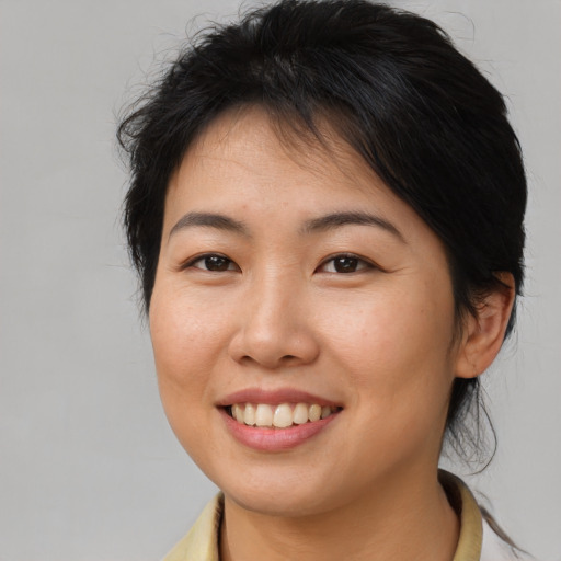 Joyful asian young-adult female with medium  brown hair and brown eyes