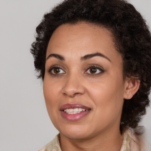 Joyful black young-adult female with medium  brown hair and brown eyes