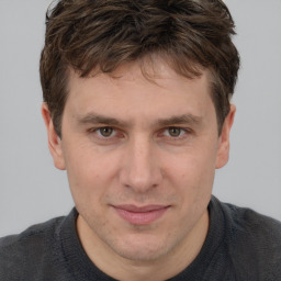 Joyful white adult male with short  brown hair and grey eyes