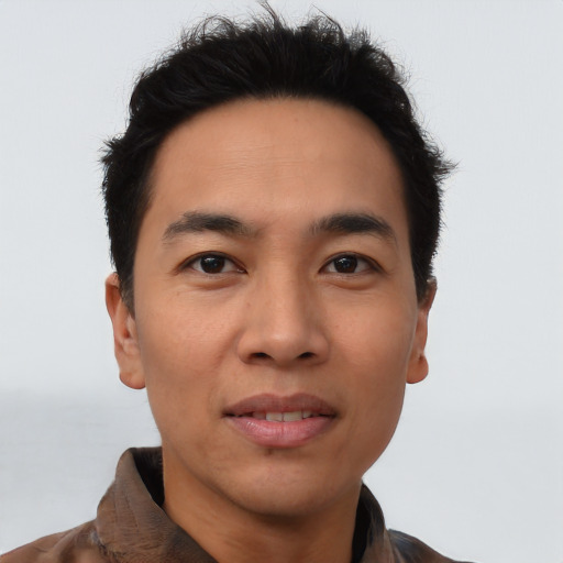 Joyful latino young-adult male with short  brown hair and brown eyes