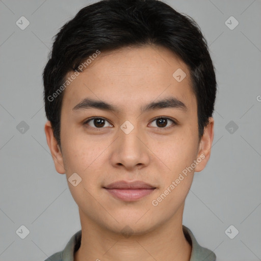 Joyful asian young-adult male with short  black hair and brown eyes