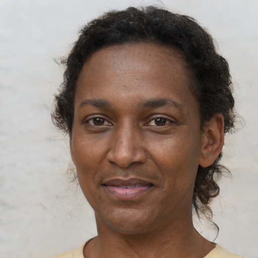 Joyful black adult female with short  brown hair and brown eyes