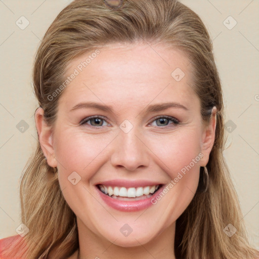 Joyful white young-adult female with long  brown hair and blue eyes