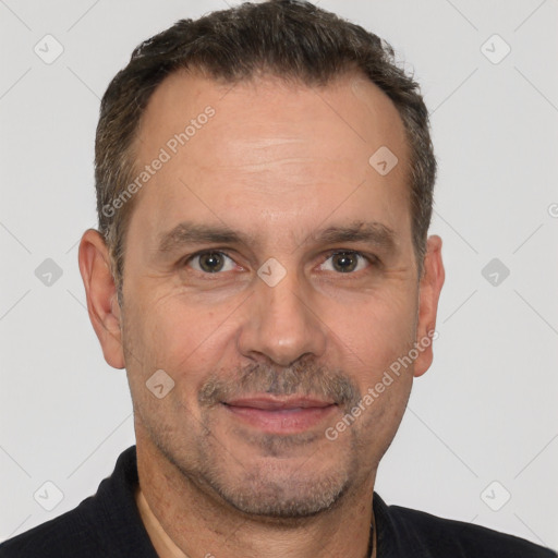 Joyful white adult male with short  brown hair and brown eyes