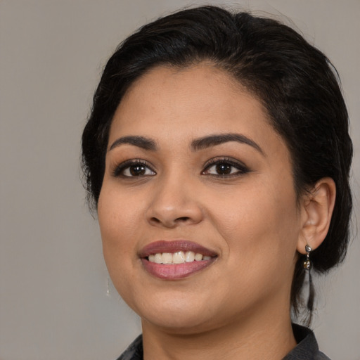 Joyful latino young-adult female with medium  black hair and brown eyes