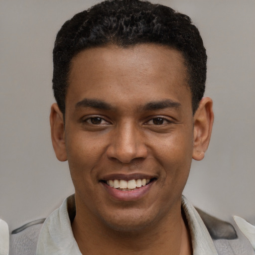 Joyful latino young-adult male with short  black hair and brown eyes