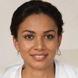 Joyful latino young-adult female with short  brown hair and brown eyes