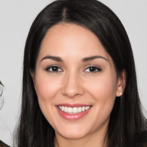 Joyful white young-adult female with long  black hair and brown eyes