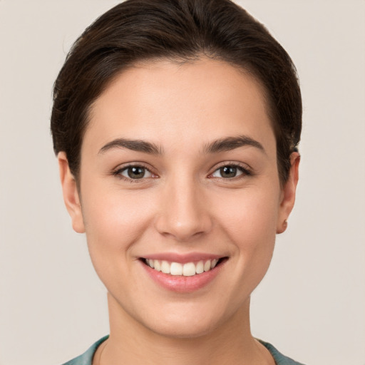 Joyful white young-adult female with short  brown hair and brown eyes