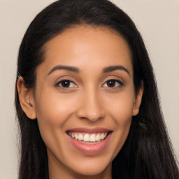 Joyful latino young-adult female with long  brown hair and brown eyes