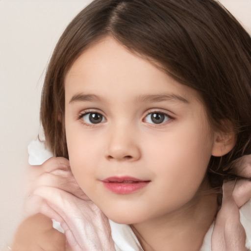 Joyful white child female with medium  brown hair and brown eyes