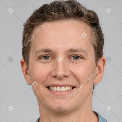 Joyful white adult male with short  brown hair and grey eyes