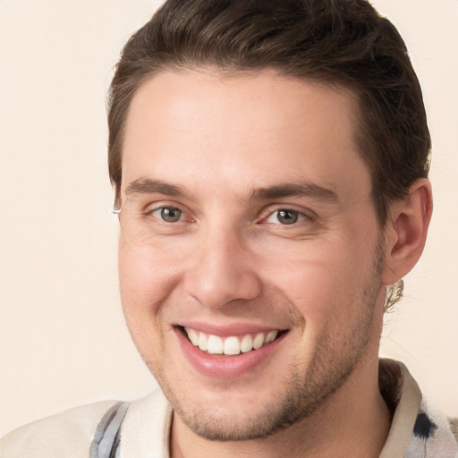 Joyful white young-adult male with short  brown hair and grey eyes