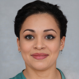 Joyful latino young-adult female with short  brown hair and brown eyes