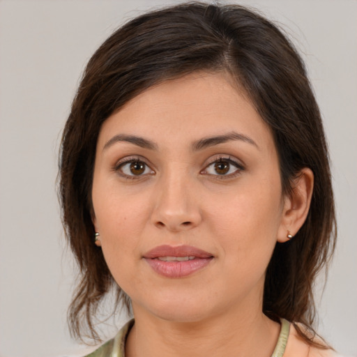 Joyful white young-adult female with medium  brown hair and brown eyes