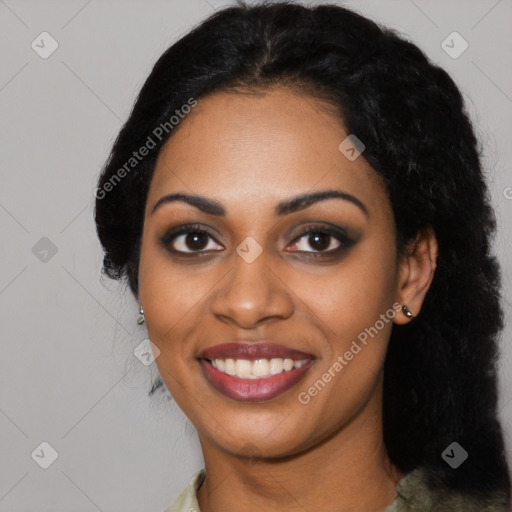 Joyful black young-adult female with long  black hair and brown eyes