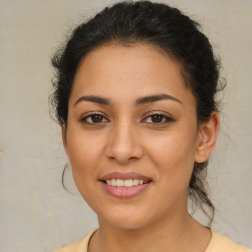 Joyful latino young-adult female with medium  brown hair and brown eyes