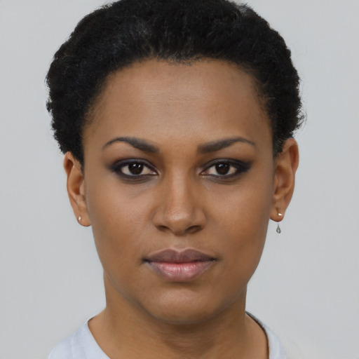Joyful black young-adult female with short  black hair and brown eyes